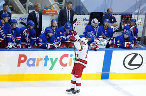 TORONTO, ONTARIO – AUGUST 04: Sebastian Aho #20 of the Carolina Hurricanes celebrates his second goal as he skates past the New York Rangers bench during the third period in Game Three of the Eastern Conference Qualification Round prior to the 2020 NHL Stanley Cup Playoffs at Scotiabank Arena on August 04, 2020, in Toronto, Ontario, Canada. (Photo by Andre Ringuette/Freestyle Photo/Getty Images)