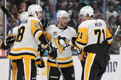 Nov 4, 2023; San Jose, California, USA; Pittsburgh Penguins right wing Reilly Smith (center) celebrates with defenseman Marcus Pettersson (28) and right wing Bryan Rust (obscured) and center Evgeni Malkin (71) after scoring a goal against the San Jose Sharks during the first period at SAP Center at San Jose. Mandatory Credit: Darren Yamashita-USA TODAY Sports