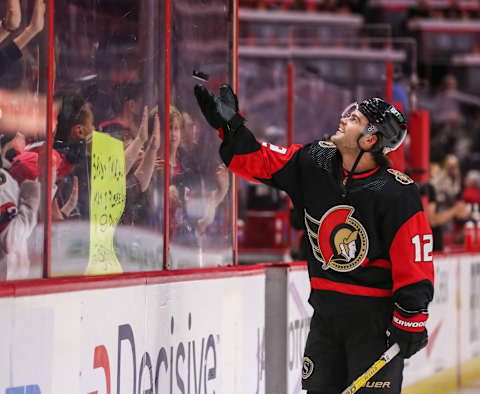 Alex DeBrincat flips a puck to a fan prior to a game against the New York Rangers. (Photo by Chris Tanouye/Freestyle Photography/Getty Images)