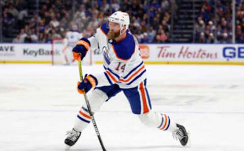 Mar 6, 2023; Buffalo, New York, USA; Edmonton Oilers defenseman Mattias Ekholm (14) takes a shot on goal during the first period against the Buffalo Sabres at KeyBank Center. Mandatory Credit: Timothy T. Ludwig-USA TODAY Sports