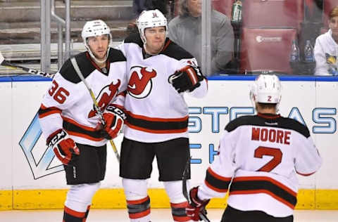 Nov 3, 2016; Sunrise, FL, USA; New Jersey Devils right wing PA Parenteau (center) celebrates with teammates after scoring a goal against Florida Panthers during the third period at the BB&T Center. The Florida Panthers defeat the New Jersey Devils 4-3 in overtime. Mandatory Credit: Jasen Vinlove-USA TODAY Sports