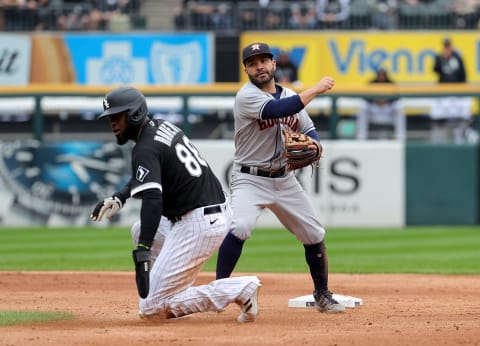 CHICAGO, ILLINOIS – OCTOBER 12: Jose Altuve #27 of the Houston Astros turns a double play as Luis Robert #88 of the Chicago White Sox slides into second base during the 3rd inning of Game 4 of the American League Division Series at Guaranteed Rate Field on October 12, 2021 in Chicago, Illinois. (Photo by Jonathan Daniel/Getty Images)