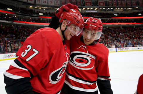 RALEIGH, NC – MARCH 24: Andrei Svechnikov #37 of the Carolina Hurricanes scores the game winning goal in overtime and is congratulated by teammate Teuvo Teravainen #86 during an NHL game agains the Montreal Canadiens on March 24, 2019 at PNC Arena in Raleigh, North Carolina. (Photo by Gregg Forwerck/NHLI via Getty Images)