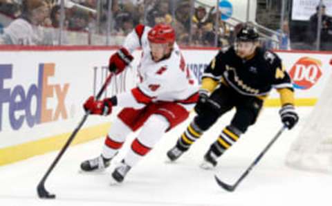 Dec 22, 2022; Pittsburgh, Pennsylvania, USA; Carolina Hurricanes center Jack Drury (18) moves the puck against Pittsburgh Penguins defenseman Jan Rutta (44) during the second period at PPG Paints Arena. Mandatory Credit: Charles LeClaire-USA TODAY Sports