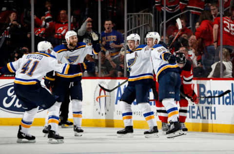 NEWARK, NJ – MARCH 30: Robert Bortuzzo #41, Ryan O’Reilly #90 and Vladimir Tarasenko #91 of the St. Louis Blues celebrate with teammate Vince Dunn #29 after Dunn scored the winning goal as Nico Hischier #13 of the New Jersey Devils skates away in back in the overtime period of an NHL hockey game at the Prudential Center in Newark, New Jersey. The Blues won 3-2. (Photo by Paul Bereswill/Getty Images)