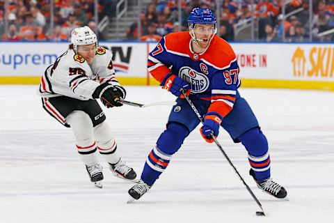 Dec 12, 2023; Edmonton, Alberta, CAN; Chicago Blackhawks forward Connor Bedard (98) tries to knock the puck away from Edmonton Oilers forward Connor McDavid (97) during the first period at Rogers Place. Mandatory Credit: Perry Nelson-USA TODAY Sports