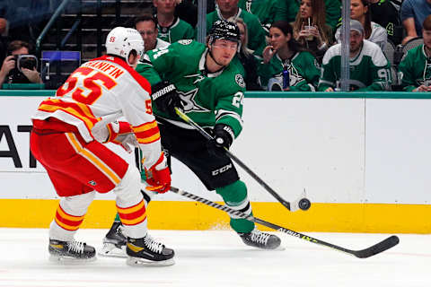 DALLAS, TEXAS – MAY 07: Noah Hanifin #55 of the Calgary Flames and Roope Hintz #24 of the Dallas Stars battle for the puck in Game Three of the First Round of the 2022 Stanley Cup Playoffs at American Airlines Center on May 07, 2022 in Dallas, Texas. (Photo by Richard Rodriguez/Getty Images)