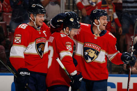 SUNRISE, FL – DECEMBER 07: Evgenii Dadonov #63 is congratulated by Jonathan Huberdeau #11 and Aleksander Barkov #16 of the Florida Panthers after scoring a goal on the first shot of the game against the Columbus Blue Jackets at the BB&T Center on December 7, 2019 in Sunrise, Florida. (Photo by Joel Auerbach/Icon Sportswire via Getty Images)