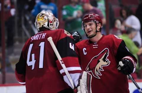 Mar 17, 2016; Glendale, AZ, USA; Arizona Coyotes right wing Shane Doan (19) celebrates with goalie Mike Smith (41) after beating the San Jose Sharks 3-1 at Gila River Arena. Mandatory Credit: Matt Kartozian-USA TODAY Sports