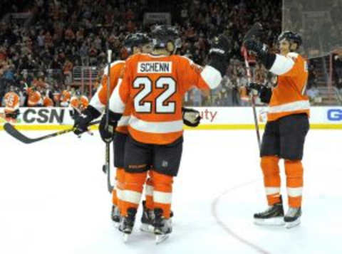 Oct 29, 2015; Philadelphia, PA, USA; Philadelphia Flyers defenseman Luke Schenn (22) celebrates his goal with center Chris VandeVelde (76) and center Vincent Lecavalier (40) against the New Jersey Devils during the second period at Wells Fargo Center. Mandatory Credit: Eric Hartline-USA TODAY Sports