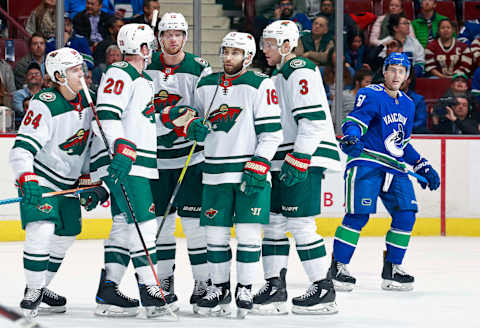 VANCOUVER, BC – OCTOBER 29: Troy Stecher #51 of the Vancouver Canucks looks on dejected as Ryan Suter #20 of the Minnesota Wild is congratulated by teammates after scoring during their NHL game at Rogers Arena October 29, 2018 in Vancouver, British Columbia, Canada. (Photo by Jeff Vinnick/NHLI via Getty Images)