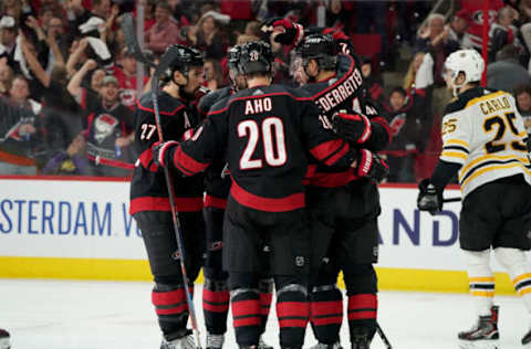 RALEIGH, NC – MAY 14: Calvin de Haan #44 of the Carolina Hurricanes celebrates with teammates Sebastian Aho #20 and Nino Niederreiter #21 after scoring a goal in Game Three of the Eastern Conference Third Round against the Boston Bruins during the 2019 NHL Stanley Cup Playoffs on May 14, 2019 at PNC Arena in Raleigh, North Carolina. (Photo by Gregg Forwerck/NHLI via Getty Images)