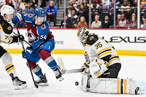 DENVER, COLORADO – DECEMBER 7: Charles Hudon #54 of the Colorado Avalanche works against Charlie McAvoy #73 of the Boston Bruins as Linus Ullmark #35 makes a save in the second period of a game at Ball Arena on December 7, 2022, in Denver, Colorado. (Photo by Dustin Bradford/Getty Images)