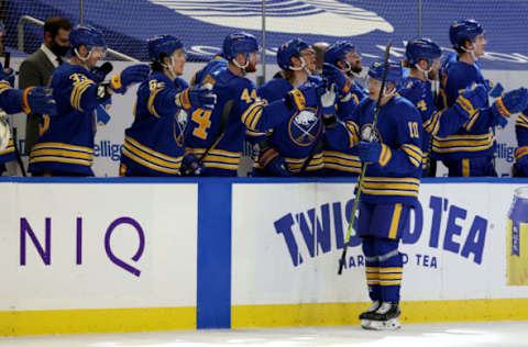 Mar 29, 2021; Buffalo, New York, USA; Buffalo Sabres defenseman Henri Jokiharju (10) celebrates with teammates after scoring a goal against the Philadelphia Flyers during the first period at KeyBank Center. Mandatory Credit: Timothy T. Ludwig-USA TODAY Sports