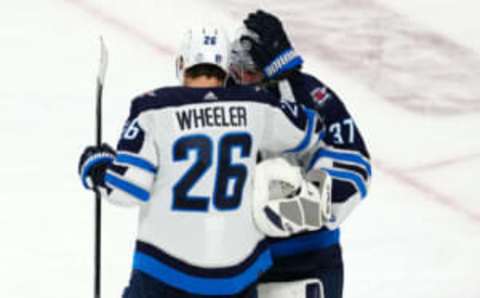 Apr 18, 2023; Las Vegas, Nevada, USA; Winnipeg Jets right wing Blake Wheeler (26) congratulates Winnipeg Jets goaltender Connor Hellebuyck (37) after the Jets defeated the Vegas Golden Knights 5-1 in game one of the first round of the 2023 Stanley Cup Playoffs at T-Mobile Arena. Mandatory Credit: Stephen R. Sylvanie-USA TODAY Sports