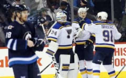 Dec 15, 2015; Winnipeg, Manitoba, CAN; St. Louis Blues goalie Jake Allen (34) celebrates with teammates after the third period against the Winnipeg Jets at MTS Centre. St. Louis Blues wins 4-3. Mandatory Credit: Bruce Fedyck-USA TODAY Sports