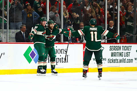 ST. PAUL, MN – OCTOBER 11: Minnesota Wild defenseman Ryan Suter (20) and left wing Jason Zucker (16), left, celebrate with left wing Zach Parise (11) after Zucker scored the game winning goal in overtime during the regular season game between the Chicago Blackhawks and the Minnesota Wild on October 11, 2018 at Xcel Energy Center in St. Paul, Minnesota. The Wild defeated the Blackhawks 4-3 in overtime. (Photo by David Berding/Icon Sportswire via Getty Images)