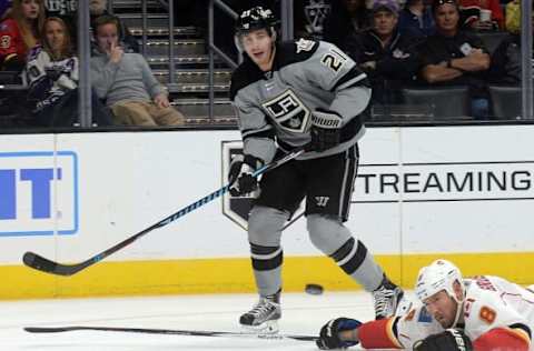 November 5, 2016; Los Angeles, CA, USA; Los Angeles Kings center Nick Shore (21) passes the puck against the defense of Calgary Flames defenseman Nicklas Grossmann (8) during the second period at Staples Center. Mandatory Credit: Gary A. Vasquez-USA TODAY Sports