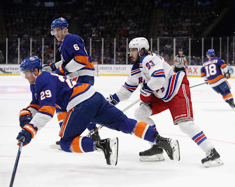 NEW YORK, NEW YORK – FEBRUARY 25: Brock Nelson #29 of the New York Islanders is tripped up by Mika Zibanejad #93 of the New York Rangers during the first period at NYCB Live’s Nassau Coliseum on February 25, 2020 in Uniondale, New York. (Photo by Bruce Bennett/Getty Images)