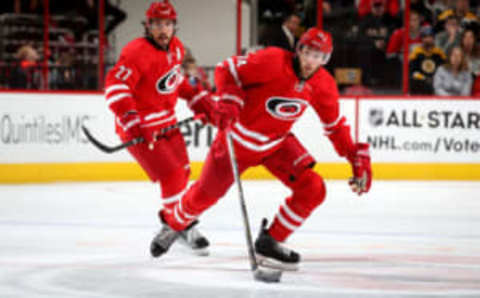 RALEIGH, NC – DECEMBER 23: Jaccob Slavin #74 of the Carolina Hurricanes controls the puck on the ice as teammate Justin Faulk #27 looks on during an NHL game on December 23, 2016 at PNC Arena in Raleigh, North Carolina. (Photo by Gregg Forwerck/NHLI via Getty Images)