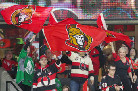 Mar 19, 2016; Ottawa, Ontario, CAN; Hockey fans wave Ottawa Senators flags during the third period against Montreal Canadiens at Canadian Tire Centre. Mandatory Credit: Jean-Yves Ahern-USA TODAY Sports