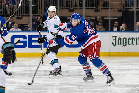 NEW YORK, NY – OCTOBER 11:New York Rangers Defensemen, Fredrik Claesson (33) fires the puck out of his zone as San Jose Sharks Forward Timo Meier (28) looks for a takeaway during a game between the New York Rangers and the San Jose Sharks on October 11, 2018 at Madison Square Garden in New York, New York. (Photo by John McCreary/Icon Sportswire via Getty Images)