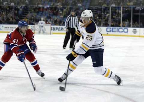 Feb 12, 2016; Buffalo, NY, USA; Montreal Canadiens center Paul Byron (41) tries to block a shot by Buffalo Sabres defenseman Jake McCabe (29) during the second period at First Niagara Center. Mandatory Credit: Timothy T. Ludwig-USA TODAY Sports