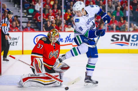 Apr 7, 2016; Calgary, Alberta, CAN; Vancouver Canucks right wing Jake Virtanen (18) screens in front of Calgary Flames goalie Joni Ortio (37) during the first period at Scotiabank Saddledome. Mandatory Credit: Sergei Belski-USA TODAY Sports