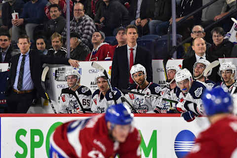 LAVAL, QC – OCTOBER 30: Head coach of the Hartford Wolf Pack Kris Knoblauch (C) watches from the bench with associate head coach Gord Murphy (L) and assistant coach David Cunniff against the Laval Rocket during the third period at Place Bell on October 30, 2019 in Laval, Canada. The Laval Rocket defeated the Hartford Wolf Pack 4-1. (Photo by Minas Panagiotakis/Getty Images)