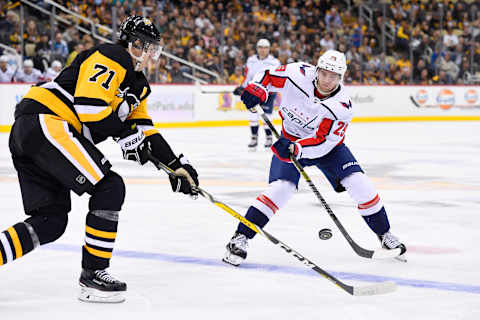 PITTSBURGH, PA – OCTOBER 04: Washington Capitals Defenseman Christian Djoos (29) chips the puck into the zone past Pittsburgh Penguins Center Evgeni Malkin (71) during the third period in the NHL game between the Pittsburgh Penguins and the Washington Capitals on October 4, 2018, at PPG Paints Arena in Pittsburgh, PA. The Penguins defeated the Capitals 7-6 in overtime. (Photo by Jeanine Leech/Icon Sportswire via Getty Images)