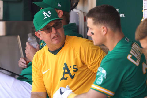 Jul 18, 2021; Oakland, California, USA; Oakland Athletics hitting coach Darren Bush (51) talks to third baseman Matt Chapman (26) during the fifth inning against the Cleveland Indians at RingCentral Coliseum. Mandatory Credit: Darren Yamashita-USA TODAY Sports