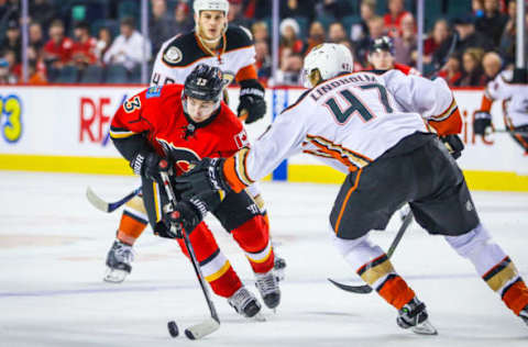 Dec 4, 2016; Calgary, Alberta, CAN; Calgary Flames left wing Johnny Gaudreau (13) and Anaheim Ducks defenseman Hampus Lindholm (47) battle for the puck during the third period at Scotiabank Saddledome. Calgary Flames won 8-3. Mandatory Credit: Sergei Belski-USA TODAY Sports