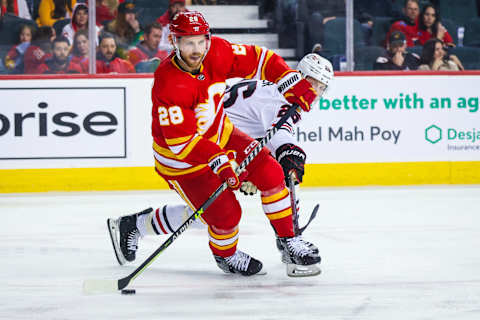 Apr 4, 2023; Calgary, Alberta, CAN; Calgary Flames center Elias Lindholm (28) controls the puck against the Chicago Blackhawks during the third period at Scotiabank Saddledome. Mandatory Credit: Sergei Belski-USA TODAY Sports