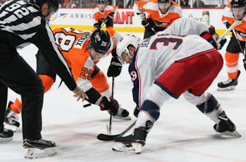 PHILADELPHIA, PA – MARCH 15: Lineman Mark Shewchyk #92 drops the puck on a face-off between Claude Giroux #28 of the Philadelphia Flyers and Boone Jenner #38 of the Columbus Blue Jackets on March 15, 2018 at the Wells Fargo Center in Philadelphia, Pennsylvania. (Photo by Len Redkoles/NHLI via Getty Images)