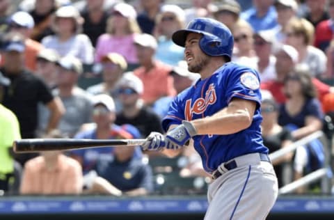 Feb 28, 2017; Jupiter, FL, USA; New York Mets catcher Travis d’Arnaud (18) connects for a solo home run against the Miami Marlins during a spring training game at Roger Dean Stadium. Mandatory Credit: Steve Mitchell-USA TODAY Sports