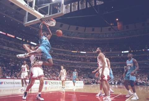 24 Jan 1996: Center Eric Mobley of the Vancouver Grizzlies hangs from the basket during a game against the Chicago Bulls at the United Center in Chicago, Illinois. The Bulls won the game 104-84.