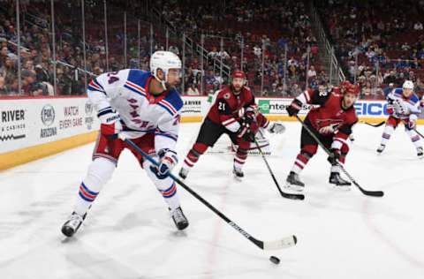 GLENDALE, AZ – JANUARY 06: Boo Nieves #24 of the New York Rangers skates with the puck while being defended by Derek Stepan #21 and Jordan Oesterle #82 of the Arizona Coyotes during the third period at Gila River Arena on January 6, 2019 in Glendale, Arizona. Coyotes won 5-0. (Photo by Norm Hall/NHLI via Getty Images)