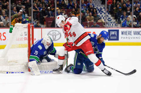 VANCOUVER, BC – DECEMBER 12: Vancouver Canucks Goaltender Jacob Markstrom (25) makes a save on Carolina Hurricanes Right Wing Martin Necas (88) as Vancouver Canucks Defenseman Jordie Benn (4) defends during their NHL game at Rogers Arena on December 12, 2019 in Vancouver, British Columbia, Canada. (Photo by Derek Cain/Icon Sportswire via Getty Images)