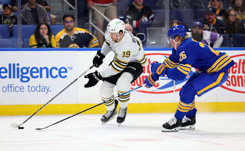 Sep 26, 2023; Buffalo, New York, USA; Boston Bruins center John Beecher (19) skates with the puck as Buffalo Sabres defenseman Rasmus Dahlin (26) defends during the first period at KeyBank Center. Mandatory Credit: Timothy T. Ludwig-USA TODAY Sports