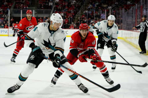 RALEIGH, NC – DECEMBER 05: Teuvo Teravainen #86 of the Carolina Hurricanes battles for a loose puck with Brenden Dillon #4 of the San Jose Sharks during an NHL game on December 5, 2019 at PNC Arena in Raleigh, North Carolina. (Photo by Gregg Forwerck/NHLI via Getty Images)