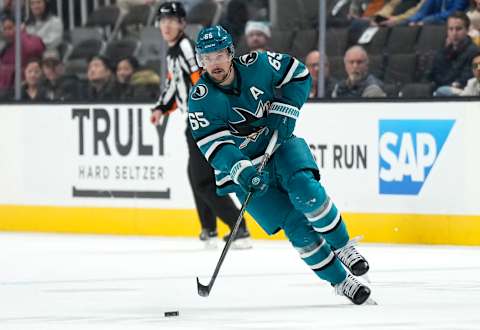 SAN JOSE, CALIFORNIA – DECEMBER 18: Erik Karlsson #65 of the San Jose Sharks skates with the puck against the Calgary Flames during the second period of an NHL hockey game at SAP Center on December 18, 2022 in San Jose, California. (Photo by Thearon W. Henderson/Getty Images)