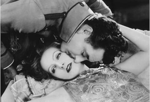 Greta Garbo reclines in a publicity still for 1926's Flesh and the Devil with frequent co-star John Gilbert.