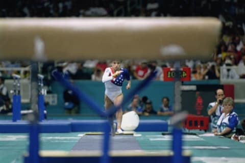 Kerri Strug hurls herself down the runway while competing in the vault on July 23, 1996 at the Georgia Dome in Atlanta, Georgia.