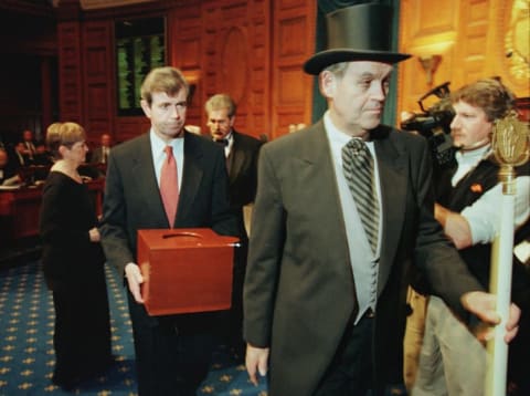 Massachusetts Secretary of the Commonwealth William Galvin, center, carries a ballot box containing the 12 Massachusetts electoral votes for Vice President Al Gore as he is led by Sergeant-at Arms Michael Rea, right, during the Electoral College voting at the Statehouse December 18, 2000 in Boston.