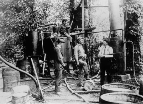 American men guarding their private beer brewing hide-out, during Prohibition.