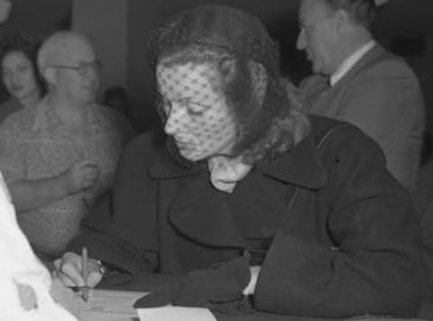 Greta Garbo fills out her U.S. citizenship paperwork circa 1950.