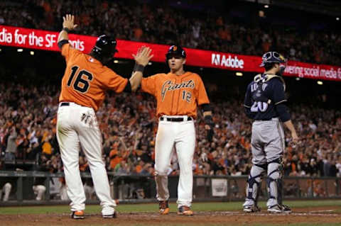 Aug 29, 2014; San Francisco, CA, USA; San Francisco Giants center fielder Angel Pagan (16) greets second baseman Joe Panik (12) at home plate after Giants catcher Buster Posey (not pictured) hit a two RBI triple in the fifth inning of their MLB baseball game with the Milwaukee Brewers at AT&T Park. Mandatory Credit: Lance Iversen-USA TODAY Sports