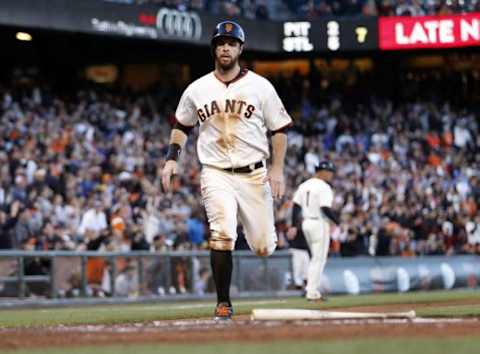 Jul 9, 2014; San Francisco, CA, USA; San Francisco Giants first baseman Brandon Belt (9) scores a run against the Oakland Athletics during the bottom of the third inning at AT&T Park. Mandatory Credit: Bob Stanton-USA TODAY Sports