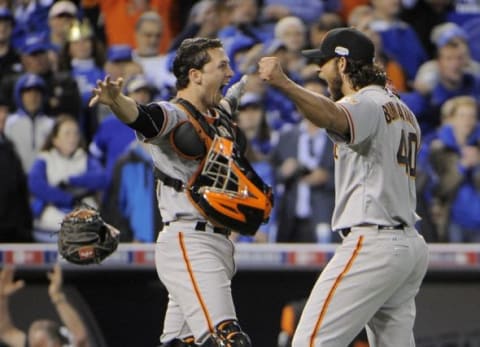 Oct 29, 2014; Kansas City, MO, USA; San Francisco Giants pitcher Madison Bumgarner (right) celebrates with catcher Buster Posey after defeating the Kansas City Royals during game seven of the 2014 World Series at Kauffman Stadium. Mandatory Credit: John Rieger-USA TODAY Sports