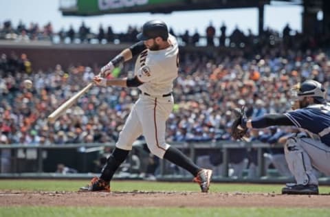 Apr 27, 2016; San Francisco, CA, USA; San Francisco Giants first baseman Brandon Belt (9) hits a sacrifice fly during the first inning against the San Diego Padres at AT&T Park. Mandatory Credit: Kenny Karst-USA TODAY Sports